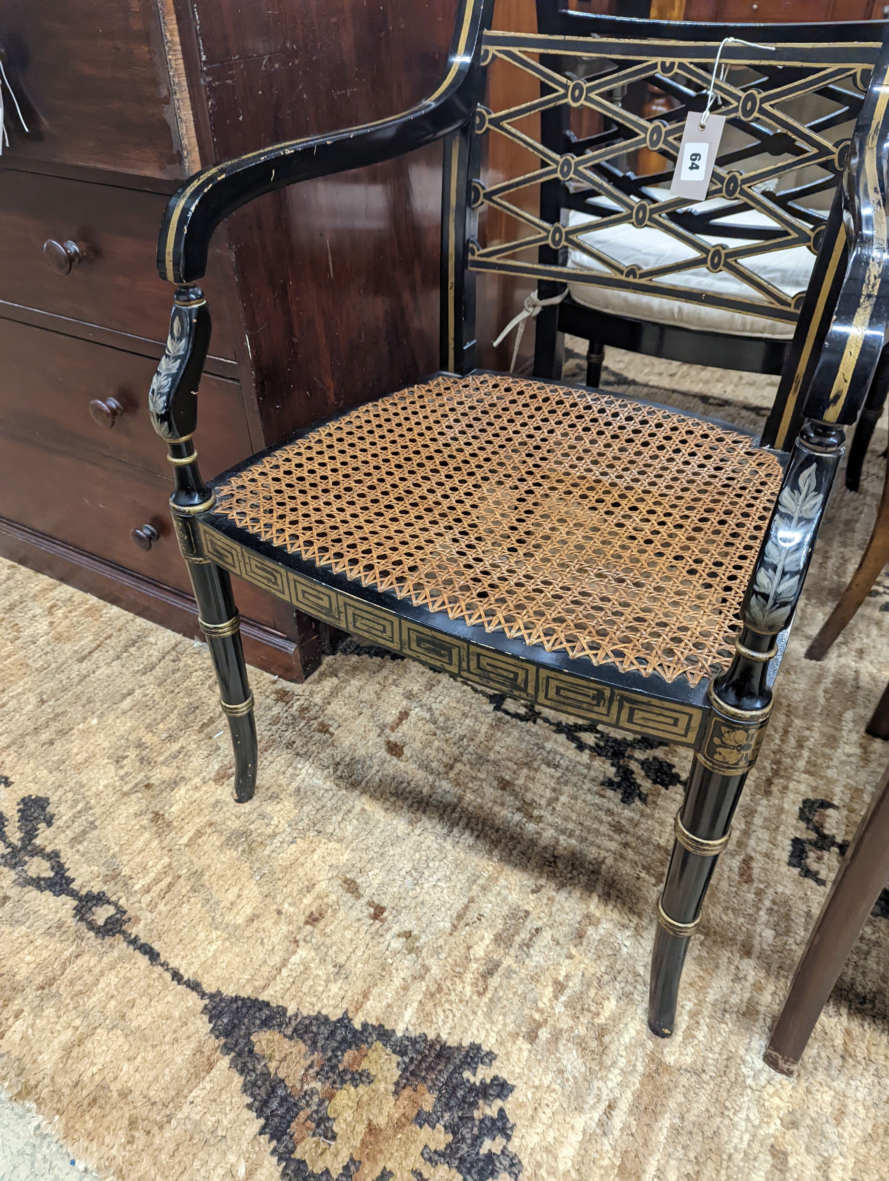 A pair of Regency style painted cane seat elbow chairs, width 52cm, depth 47cm, height 84cm